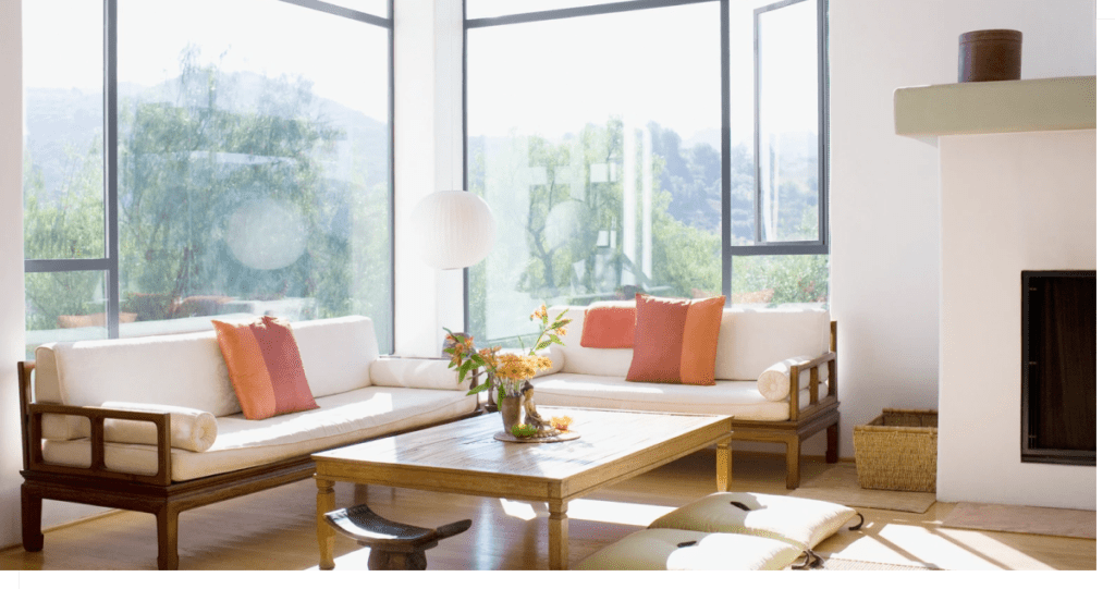 Image of well-lit living room with large windows