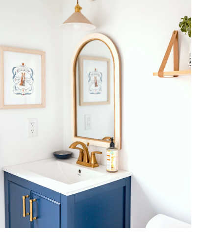 Single blue vanity with mirror and gold fixtures