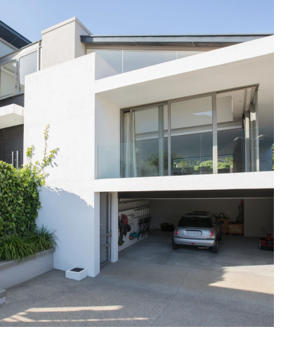 Exterior of contemporary home with large windows and open garage with car