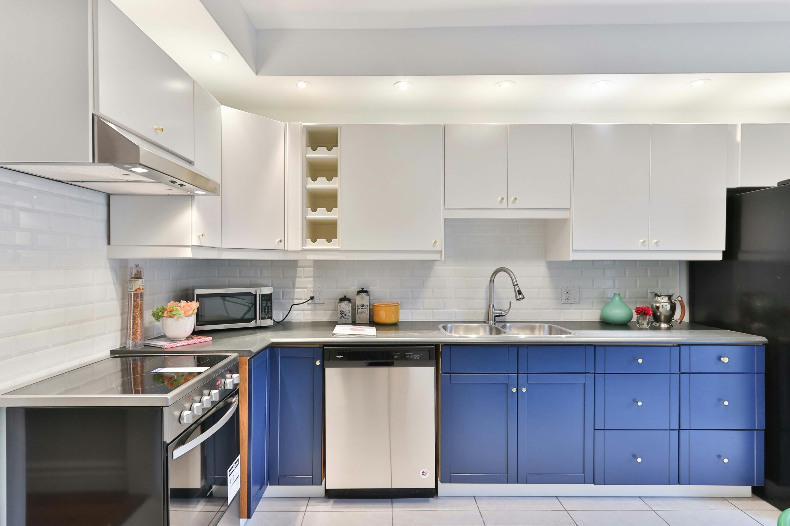 Contemporary kitchen with blue lower cabinets