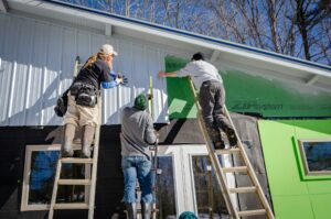 Contractors installing Zip system sheathing on a new home.
