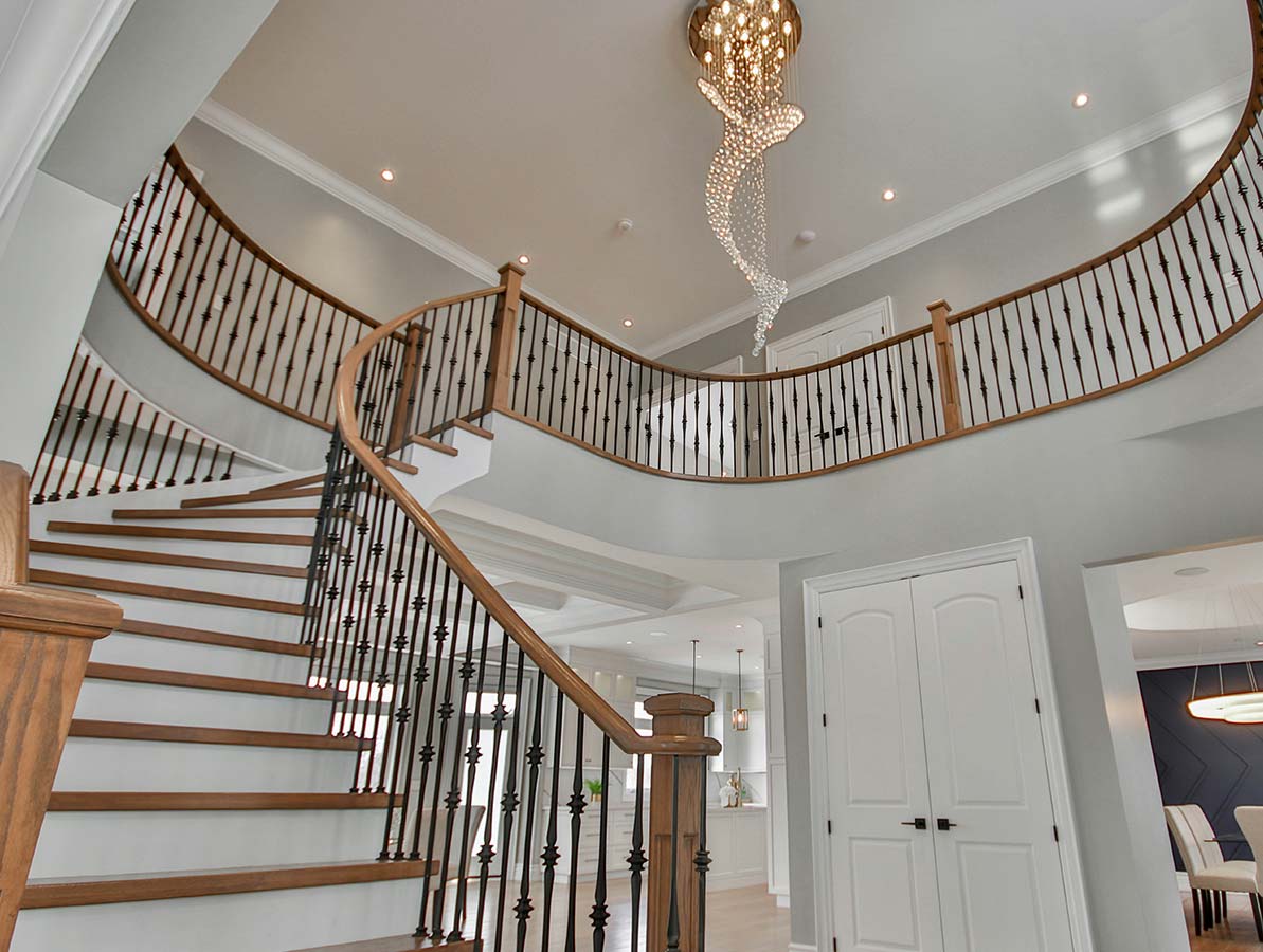 A grand staircase with a chandelier.