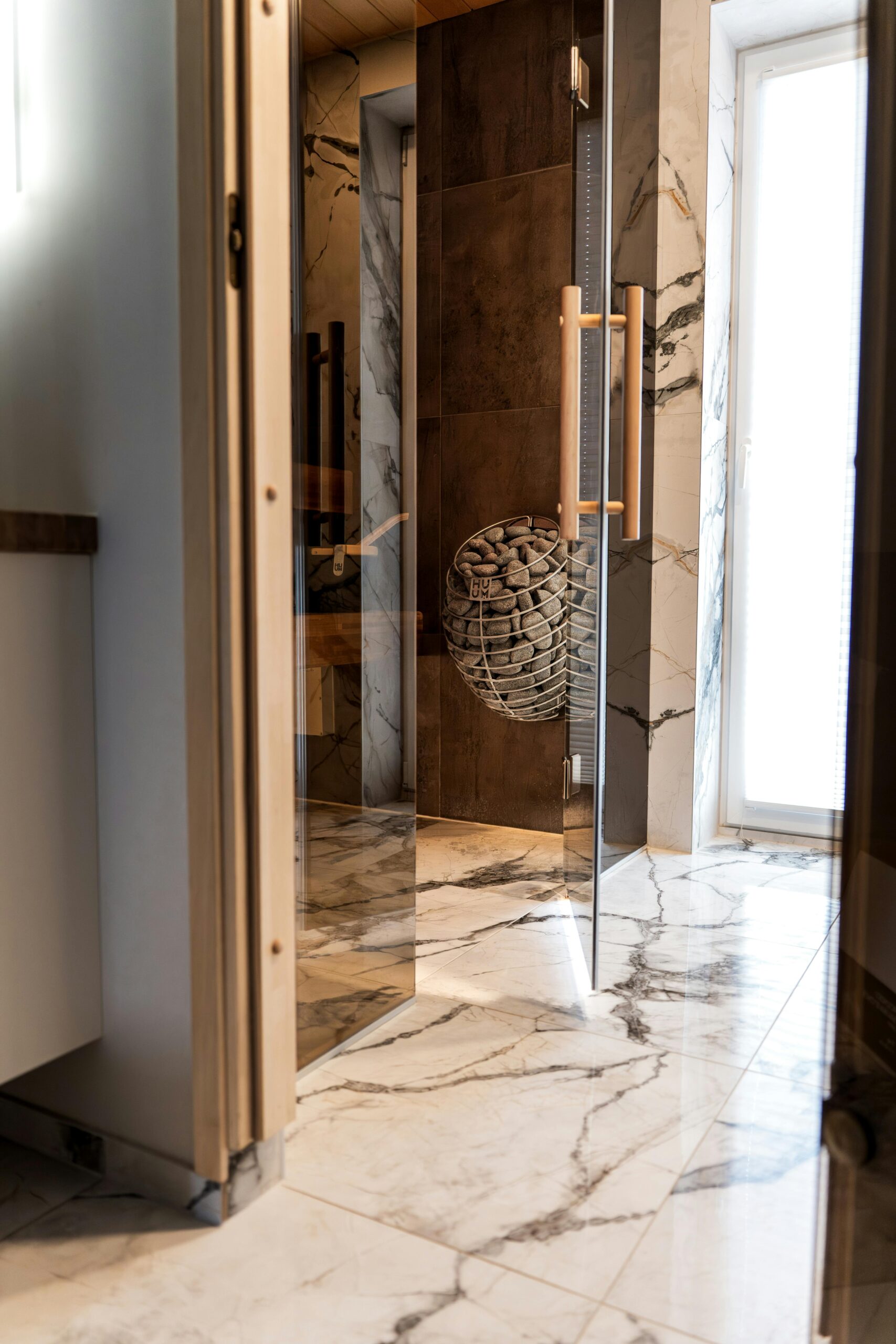 A luxury indoor sauna with marble flooring