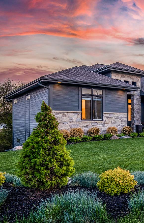 A newly constructed luxury house with a lawn