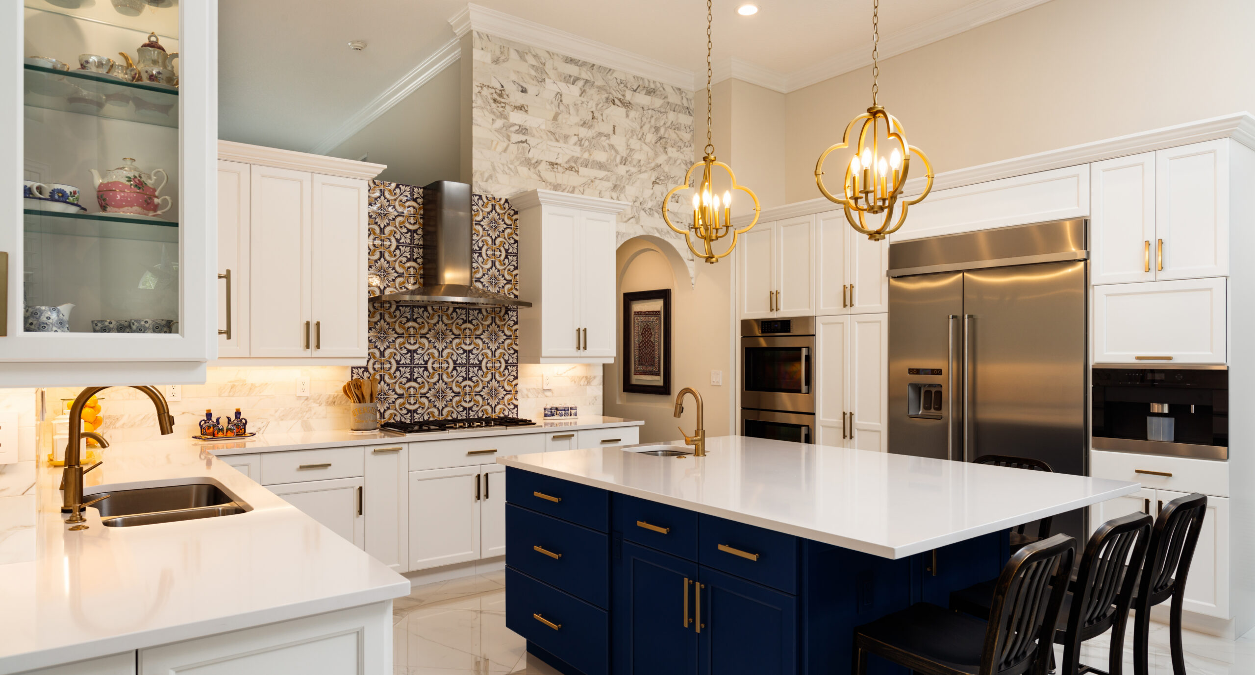 A luxury, spacious kitchen with beautiful lighting, decor & seating arrangement