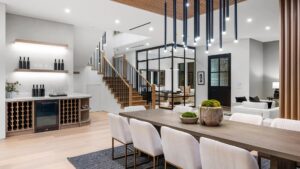 Interiors of a luxurious home with hanging lights, a big dining table & chairs
