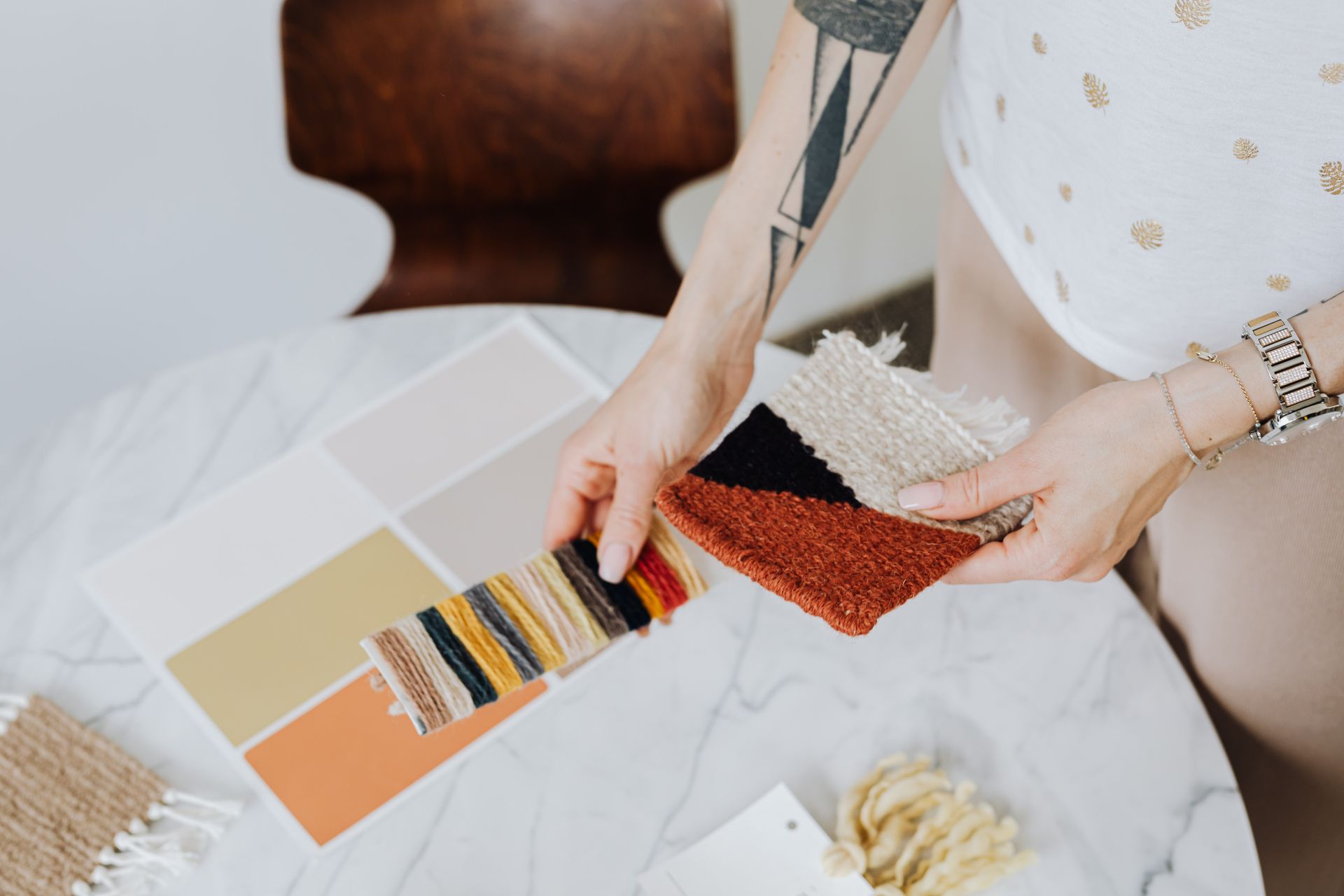 Designer selecting fabric swatches and paint color samples for an interior