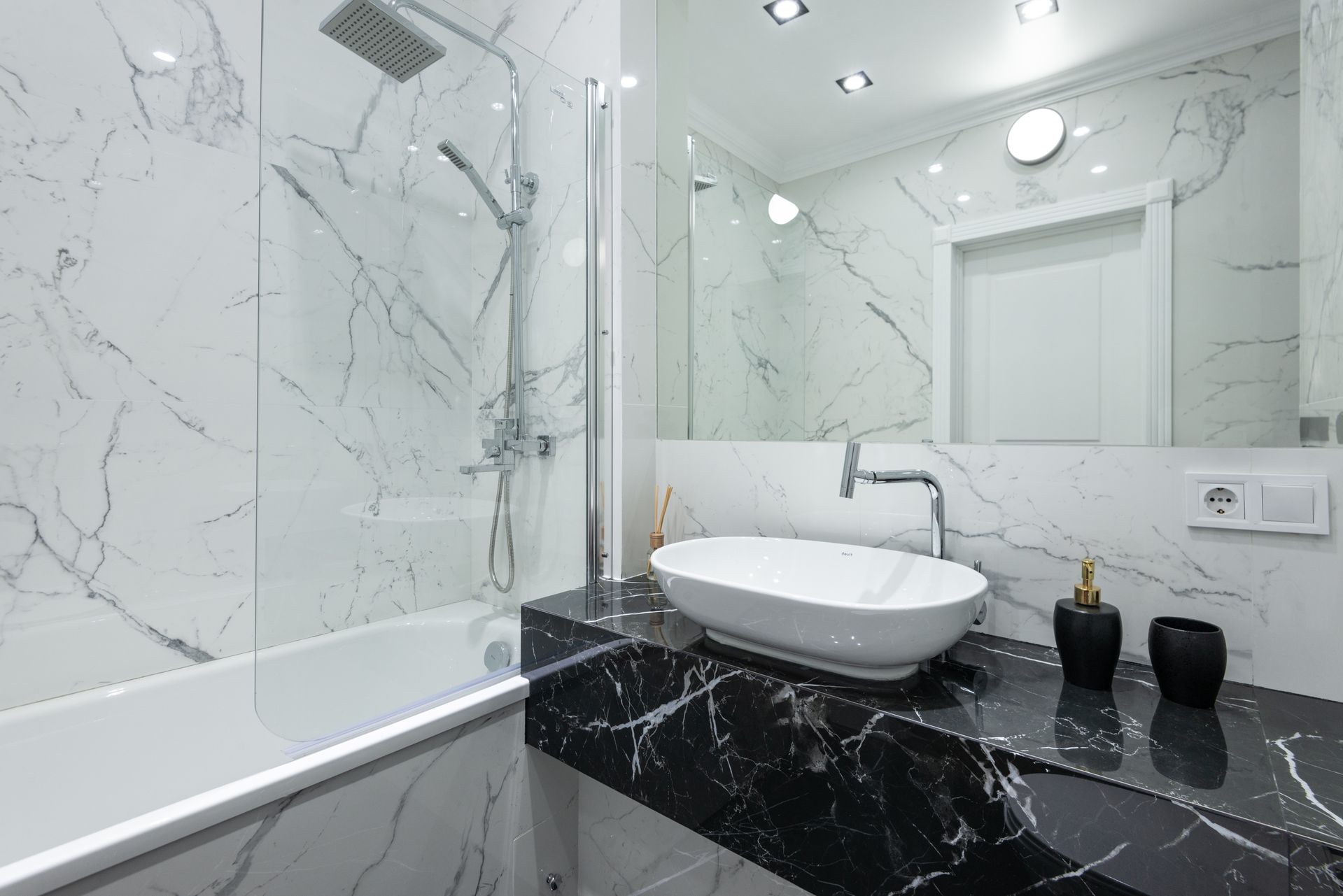 Luxury bathroom with marble walls, vessel sink, and contemporary fixtures