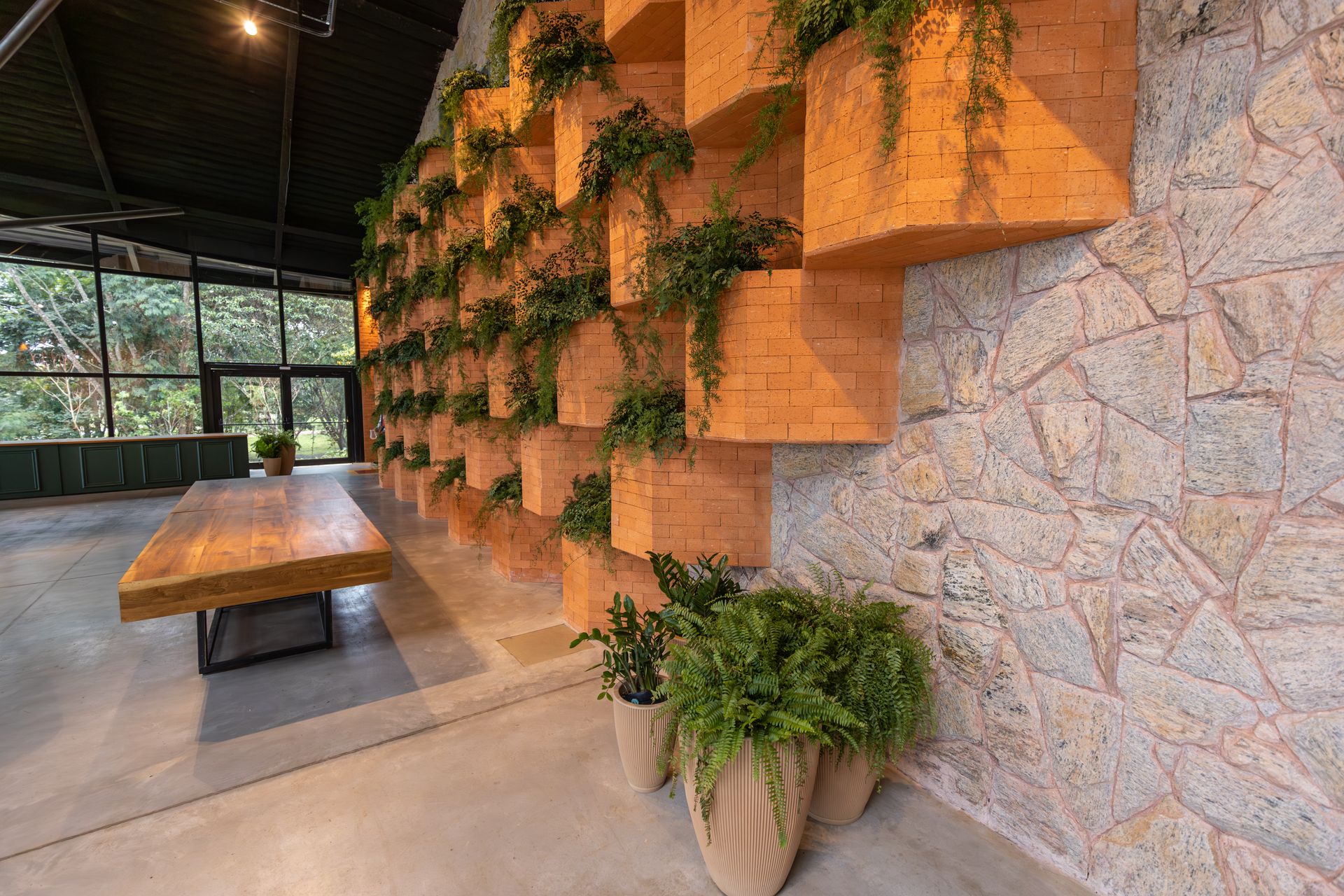 Brick, stone, wood, and indoor greenery in a biophilic interior