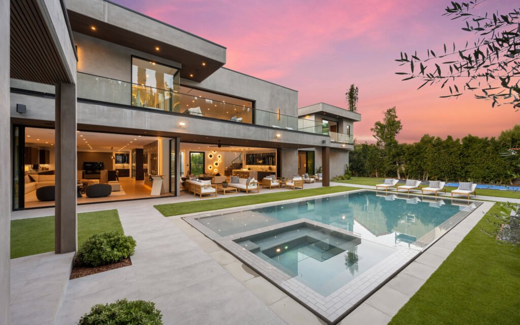 Two-story contemporary Atherton home with glass railings, indoor-outdoor living, and a pool.