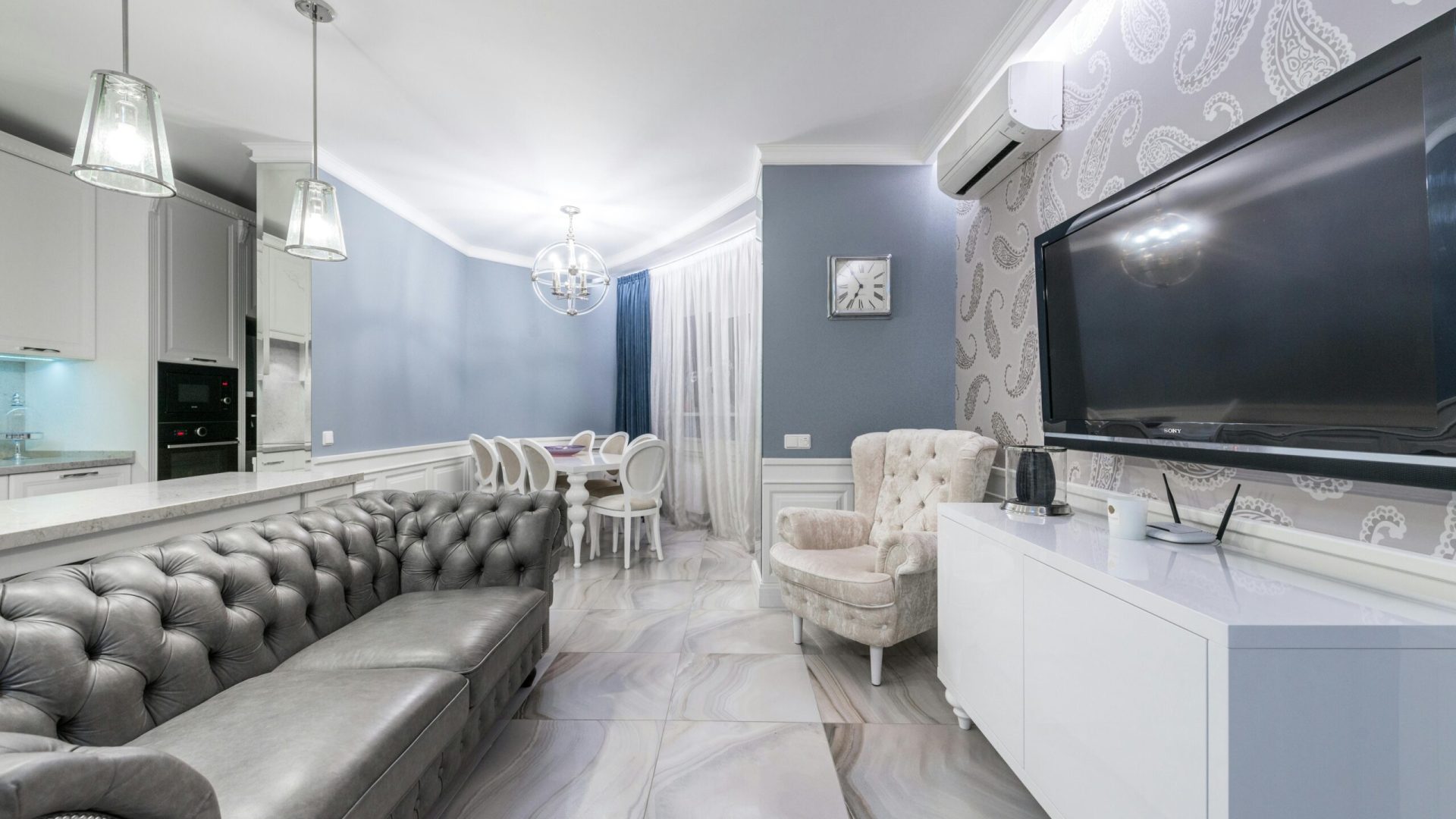 A remodeled, stylish living room with a kitchen